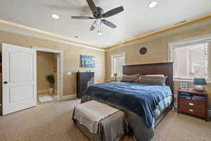 Bedroom featuring carpet, ceiling fan, and ornamental molding