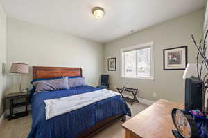 Carpeted bedroom featuring baseboards