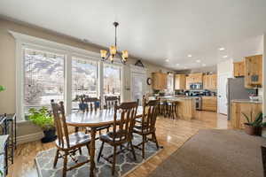 Dining space featuring light wood-type flooring and hanging lights