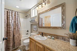 Bathroom featuring vanity and shower / tub combo with curtain