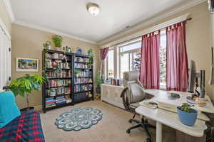 Carpeted office space featuring ornamental molding and baseboards