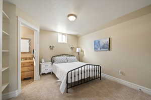 Bedroom featuring carpet floors and baseboards