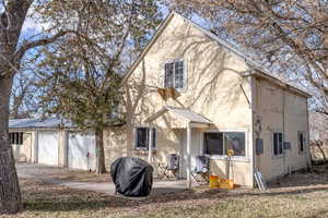 View of front facade featuring a metal roof and a garage