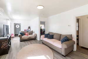 Living room with light wood-style floors and baseboards