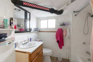 Bathroom featuring shower / bathtub combination, vanity, and light tile patterned floors