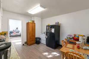 Dining/kitchen room with light wood-type flooring