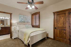 Bedroom #1 featuring carpet floors, connected bathroom, and ceiling fan
