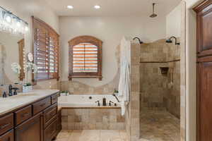 Primary Owner Full bath featuring vanity, a bath, a tile shower, and recessed lighting