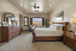 Primary Owner Suite featuring light carpet, ceiling fan, recessed lighting, and a mountain view