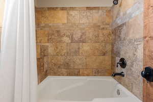 Bathroom with shower / tub combo with curtain