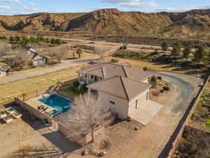 Aerial view of property and surrounding area with a mountain backdrop