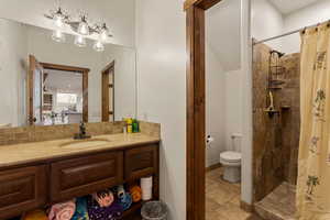 Outside Pool Bathroom featuring a stall shower, vanity, and light stone finish flooring