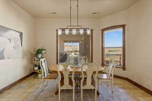 Dining room featuring stone tile floors and plenty of natural light