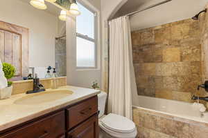 Bathroom #2 with tiled shower / bath combo and vanity