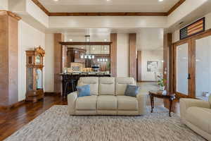 Living area with wood-type flooring and recessed lighting