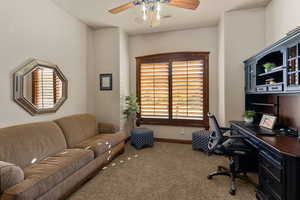 Carpeted office space featuring ceiling fan and plenty of natural light