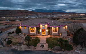 Mediterranean / spanish home with a mountain view, a tile roof, and stucco siding