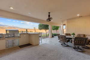 View of patio with an outdoor kitchen / dining area and a mountain view