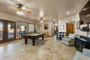 Game room with pool table, stone tile floors, ceiling fan, french doors, and recessed lighting