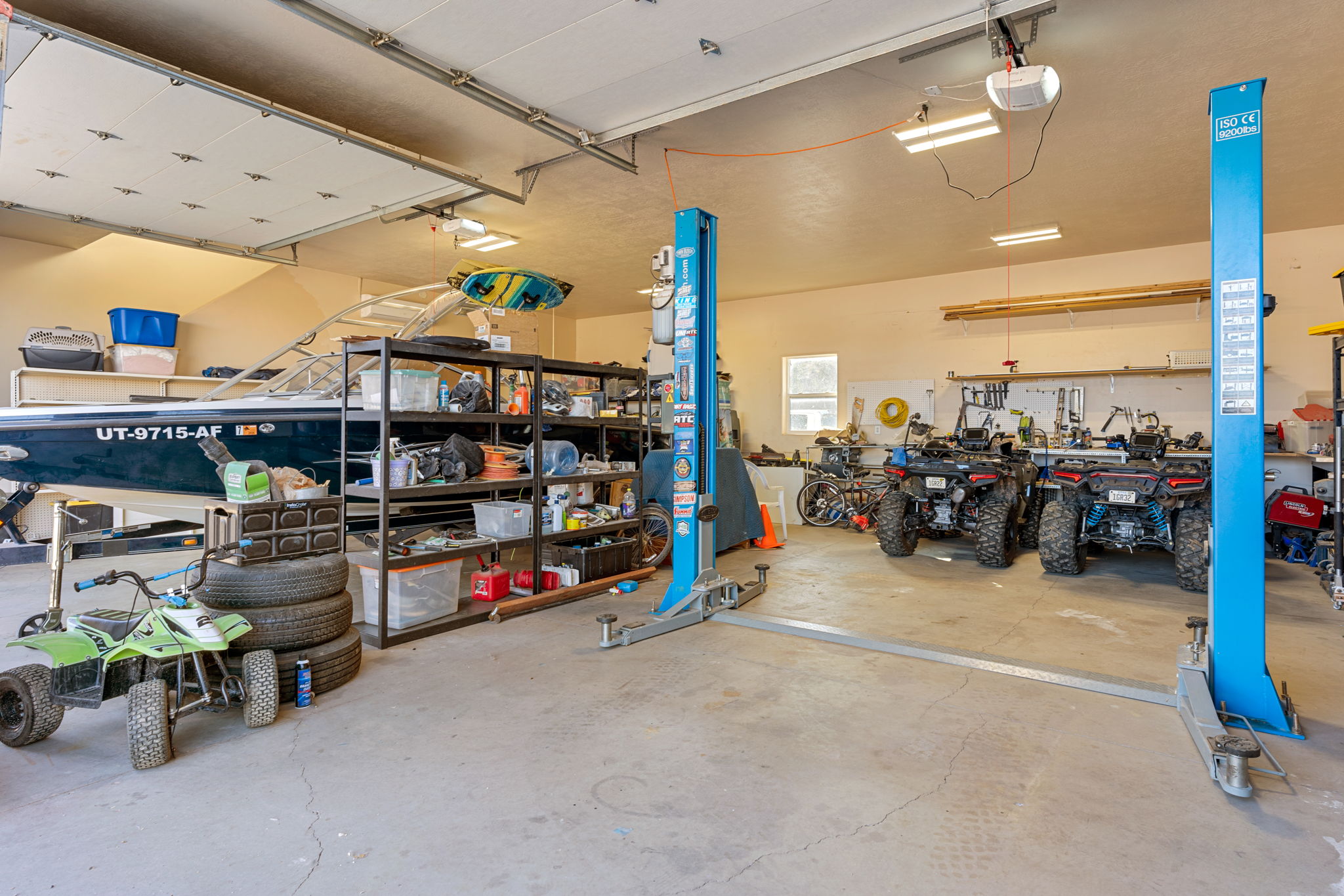 Garage featuring a workshop area and a garage door opener