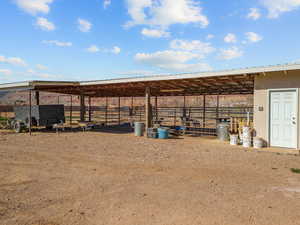 View of yard with an outbuilding and an exterior Corral structure & tack shed.