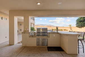 View of patio featuring an outdoor kitchen and a mountain view