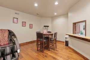 Dining area with light wood-type flooring and recessed lighting