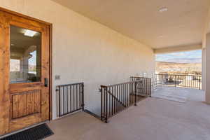 Doorway to property with a mountain view, a patio, and stucco siding