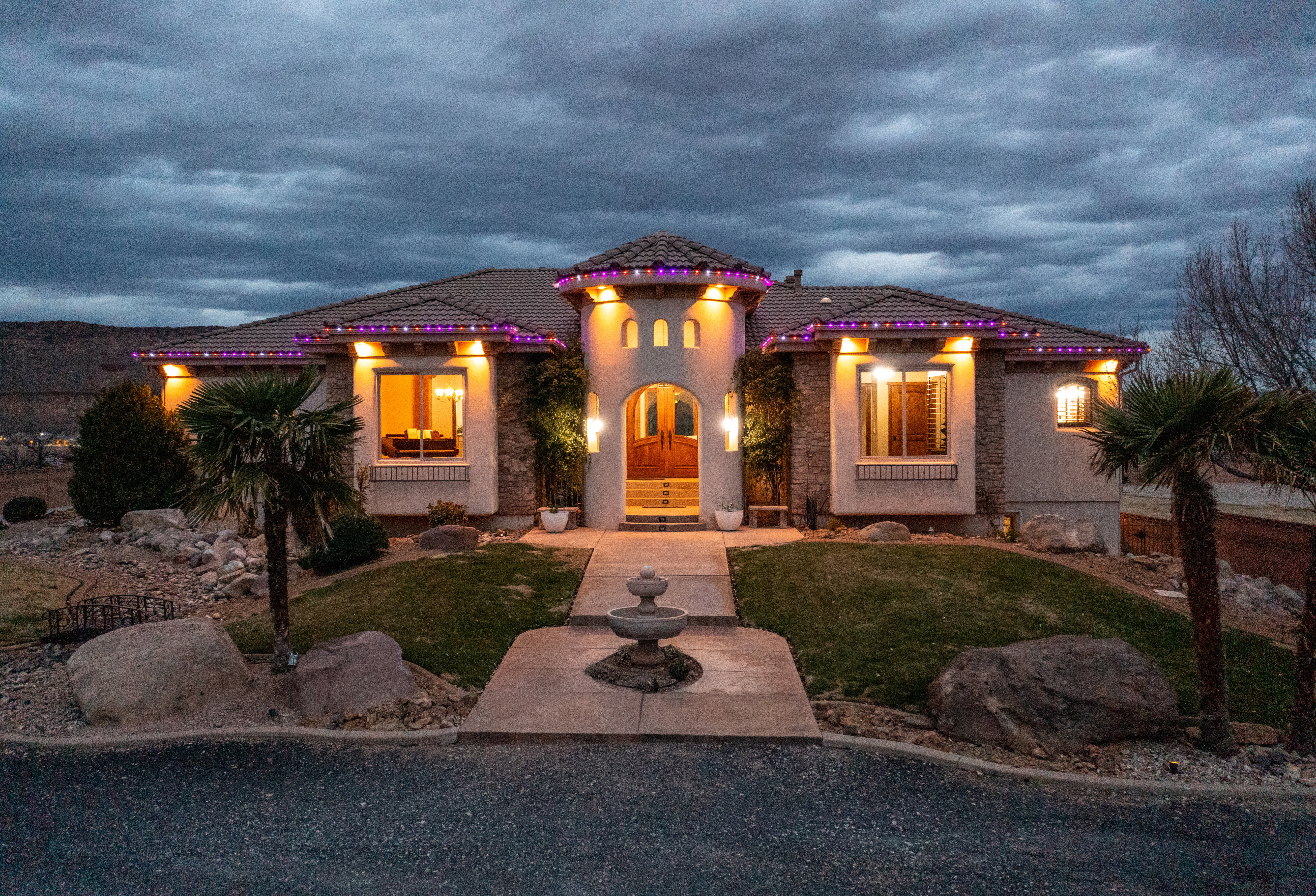 Mediterranean / spanish-style home featuring stucco siding, a front yard, and a tile roof