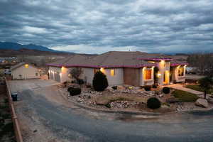 Mediterranean / spanish-style house with driveway, a tiled roof, stucco siding, an attached garage, and a mountain view