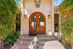 Property entrance featuring french doors and stucco siding