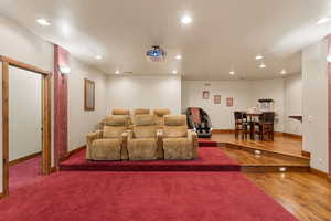 Home theater featuring recessed lighting and hardwood / wood-style floors