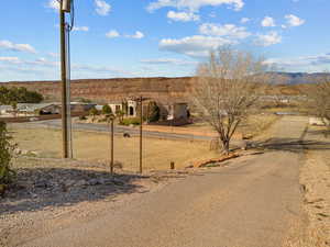 View of asphalt drive-way with a mountain view