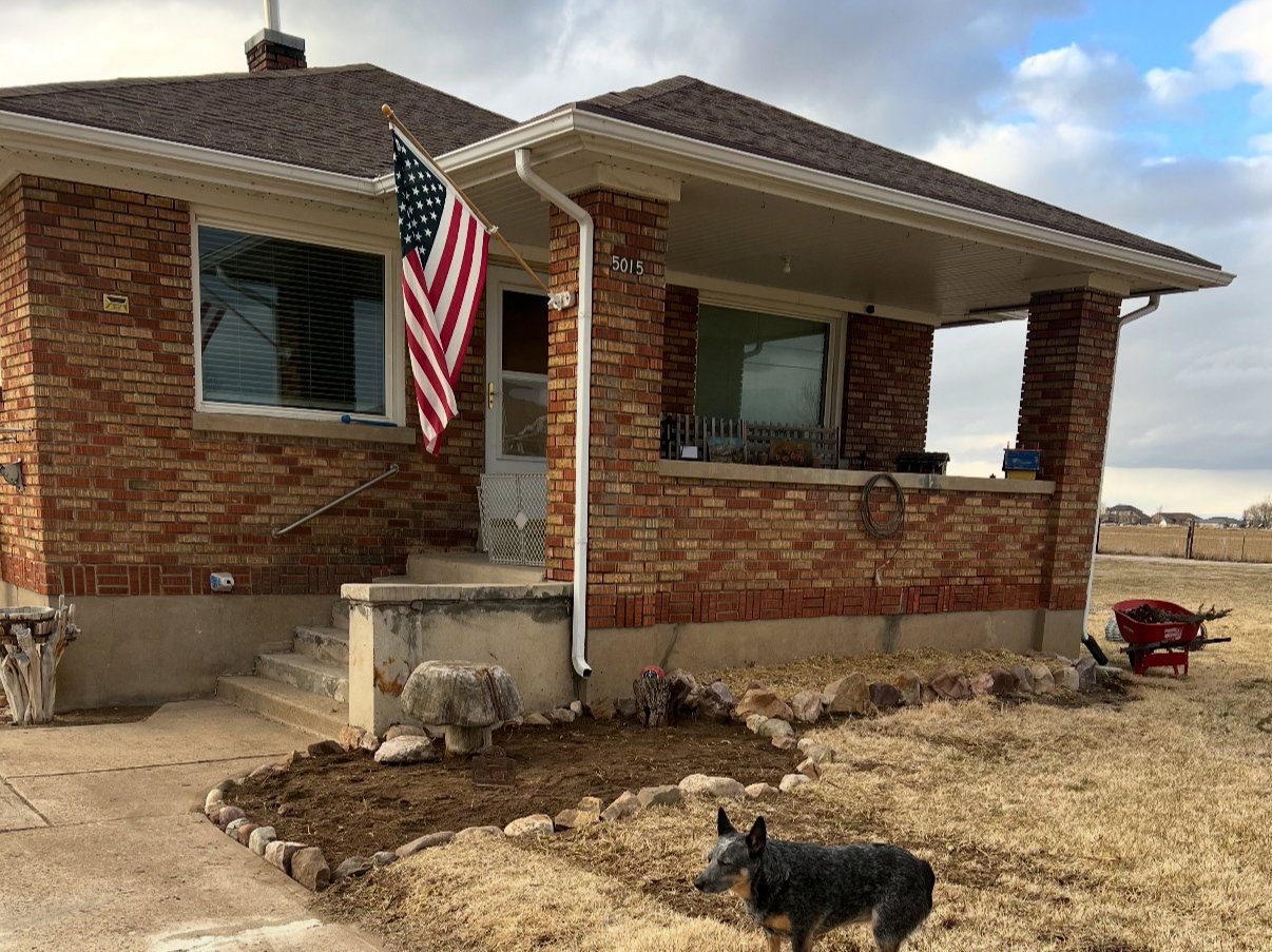 Single story home featuring brick siding and a shingled roof