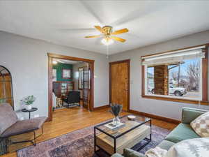 Living room featuring wood finished floors and a ceiling fan