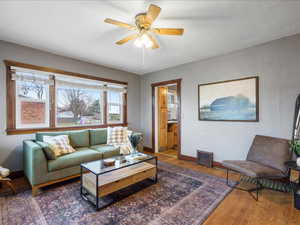 Living room featuring ceiling fan and wood finished floors