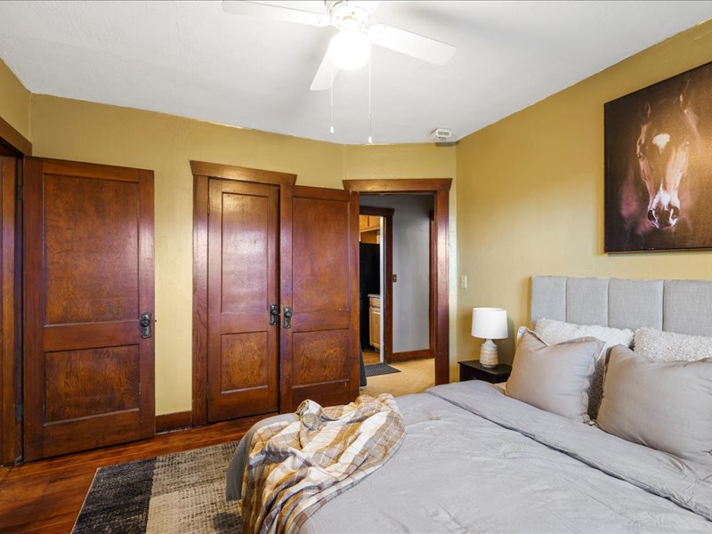 Bedroom with a closet, wood finished floors, and ceiling fan