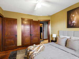 Bedroom with a closet, wood finished floors, and ceiling fan