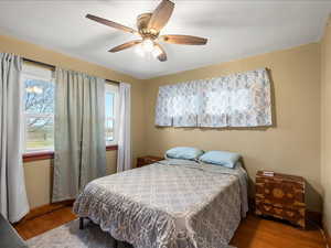 Bedroom featuring wood finished floors and ceiling fan