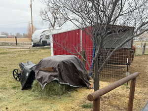 View of green lawn featuring an outbuilding