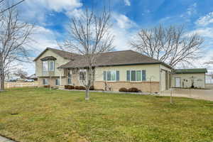Tri-level home featuring brick siding, driveway, and an attached garage