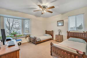 Bedroom featuring light colored carpet and ceiling fan