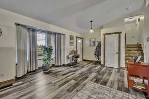 Entryway featuring light wood-style floors and lofted ceiling