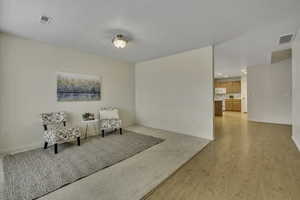 Sitting room featuring light wood-style flooring and recessed lighting