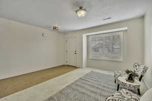Sitting room with carpet and baseboards