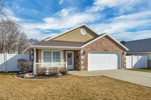 Ranch-style house with roof with shingles, brick siding, an attached garage, and concrete driveway