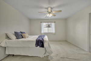 Bedroom featuring carpet floors and ceiling fan