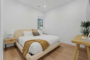 Bedroom with light wood-style floors, recessed lighting, and a ceiling fan