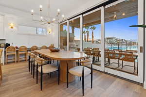 Dining area with suspended lighting and light wood finished floors