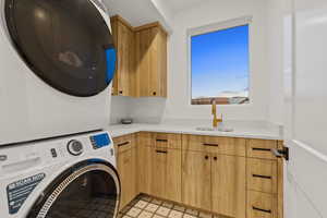 Laundry area with cabinet space and stacked washer / drying machine